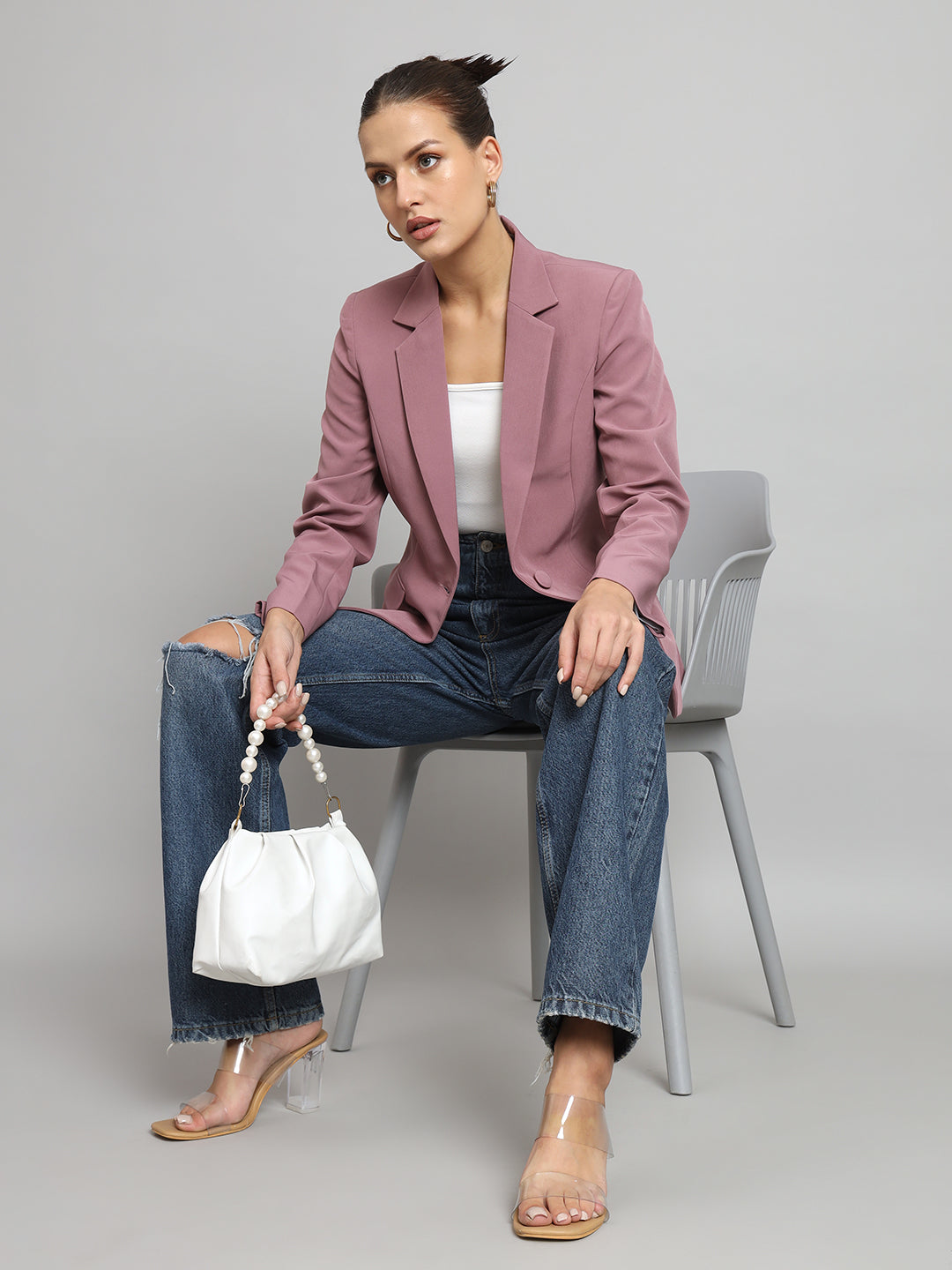 Notch collar stretch blazer in dusty pink worn with jeans.