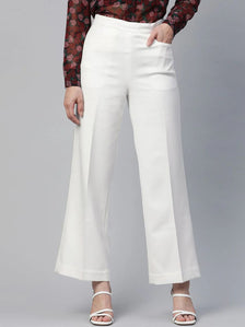 Baby Pink Textured Stretchable Top With Dainty Bow Closures Paired With Classic Regular Fit Mid-Rise Parallel Trousers